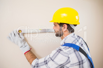 Construction worker using spirit level