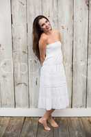 Pretty brunette posing in white dress