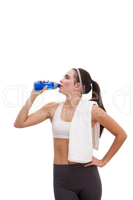 Fit brunette drinking from sports bottle