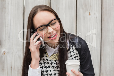 Pretty hipster talking on phone having coffee
