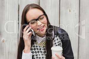 Pretty hipster talking on phone having coffee