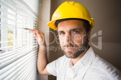 Handyman looking out the window