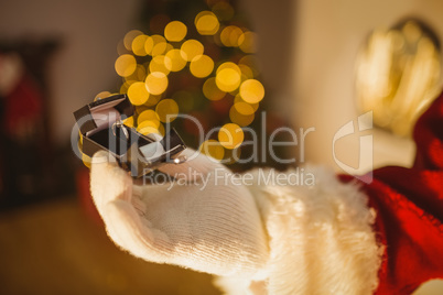 Hand of santa holding jewelry box