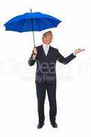 Businessman under umbrella with hand out