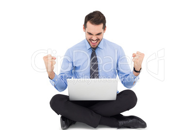 Businessman sitting with his laptop cheering Businessman sitting with his laptop cheering