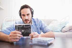 Man holding cd while listening to music