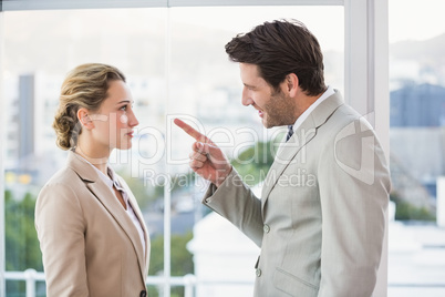 Angry man pointing at his colleague