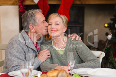 Mature man kissing the cheek of his wife