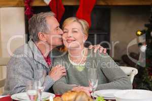 Mature man kissing the cheek of his wife