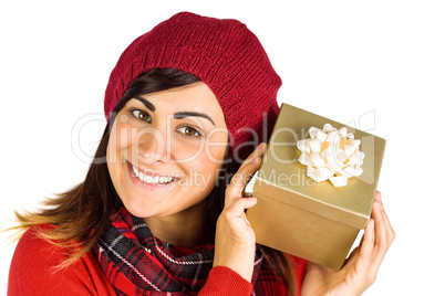 Pretty brunette in hat holding a gift