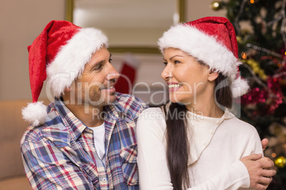 Happy couple hugging on the couch