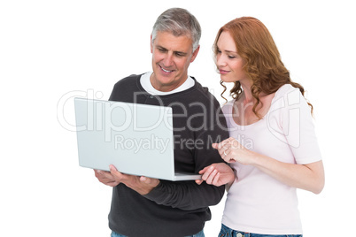 Casual couple using laptop together