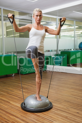 Woman doing fitness exercise in fitness studio