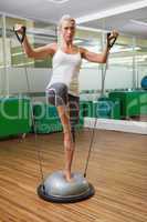 Woman doing fitness exercise in fitness studio