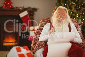 Relaxed santa writing list with a quill