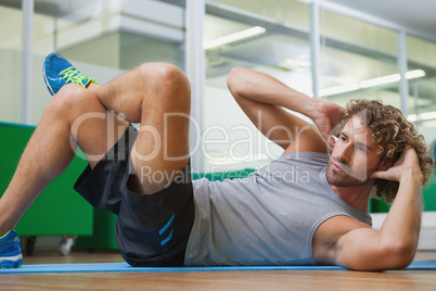 Handsome young man doing fitness exercise