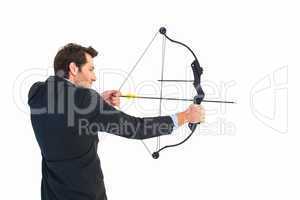 Businessman shooting bow and arrow