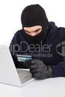 Angry hacker using laptop and credit card