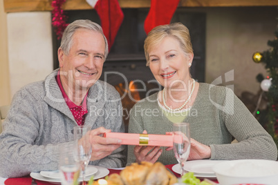 Senior couple holding a christmas present