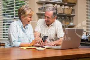 Senior couple working out their bills