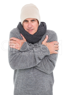 Casual man shivering in warm clothing