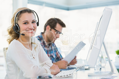 Pretty designer with headphone working on computer