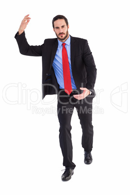 Unsmiling businessman holding something with hands