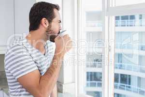 Young man looking out his window