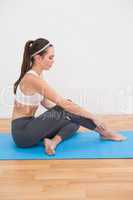 Fit woman doing yoga at home
