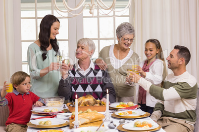 Family toasting with champagne in a christmas dinner