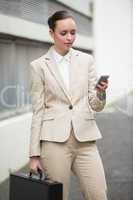 Young businesswoman sending a text