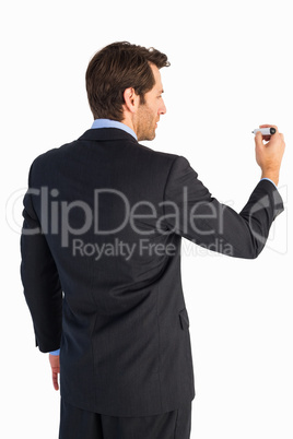 Businessman standing back to camera writing with marker