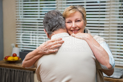 Senior couple hugging and smiling