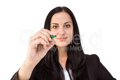 Pretty businesswoman writing with marker