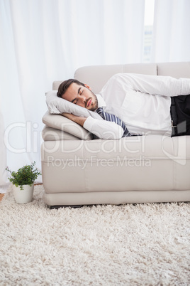 Businessman sleeping on couch after long day