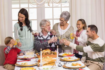 Family toasting with champagne in a christmas dinner