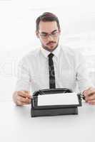 Hipster businessman using a typewriter