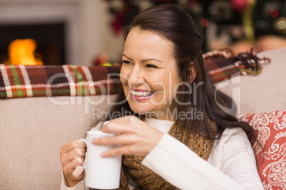 Brunette drinking hot chocolate with marshmallow