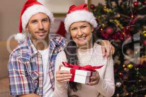 Festive couple holding christmas gifts