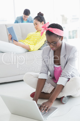 Young creative woman working on floor