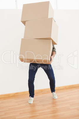 Man balancing heavy cardboard boxes