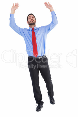 Businessman in suit pushing up with effort