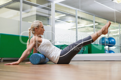 Side view of woman doing fitness exercise in gym