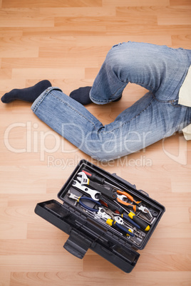 Man legs with toolbox on floor