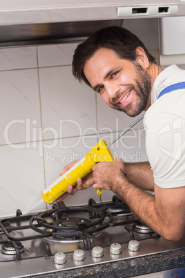 Plumber putting filling in between tiles