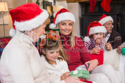 Happy family at christmas holding gifts