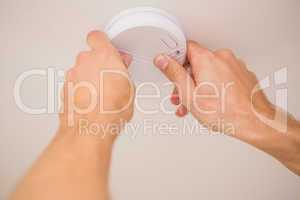 Handyman installing smoke detector