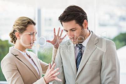 Woman shouting at male colleague