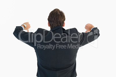 Rear view of businessman gesturing thumbs down