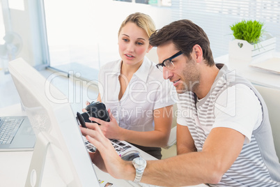 Photo editors looking at computer screen